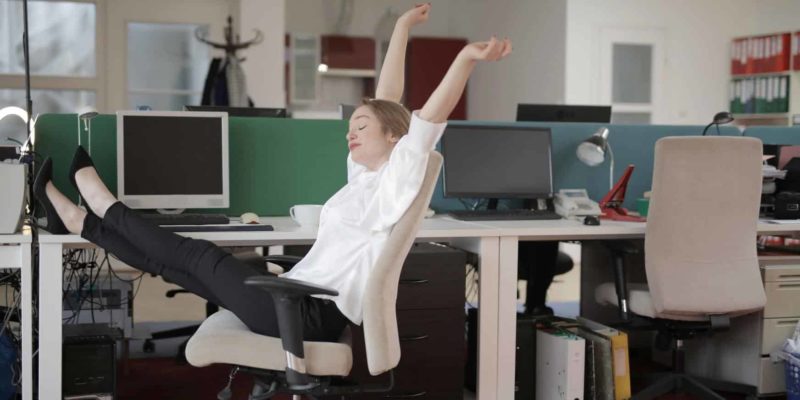 female office worker relaxing with feet on table