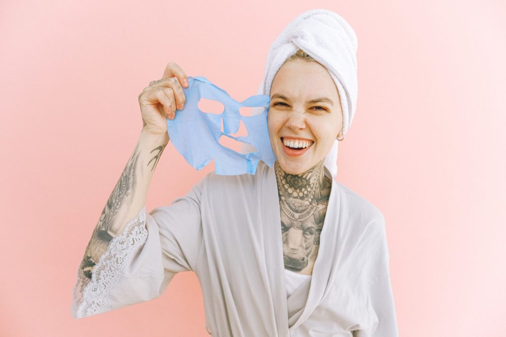 happy-woman-removing-face-mask-after-taking-bath